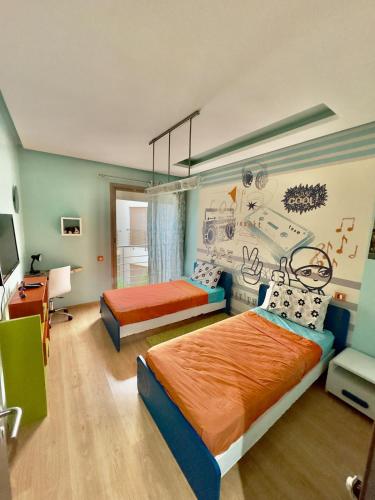 a bedroom with two beds and a painting on the wall at Cozy & stylish apartment at Parc Prestigia in Fès