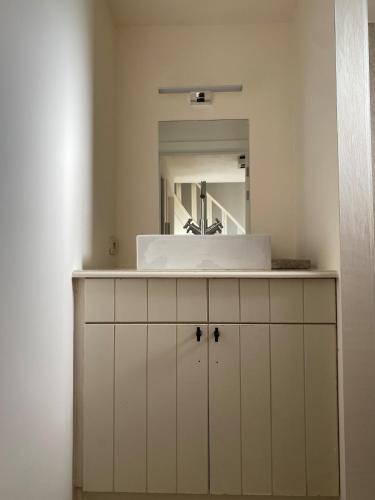a bathroom with a sink and a mirror at Ne Quid Nimis - 't Zoute in Knokke-Heist