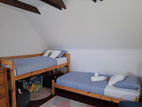 a room with two bunk beds in a room at Birkenhof Vendégház in Balatonakarattya