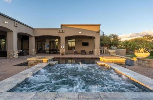 a pool in a yard with a house at HoZho Residence on Desert Views in Currys Corner