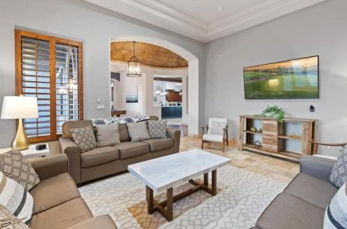 a living room with a couch and a table at HoZho Residence on Desert Views in Currys Corner