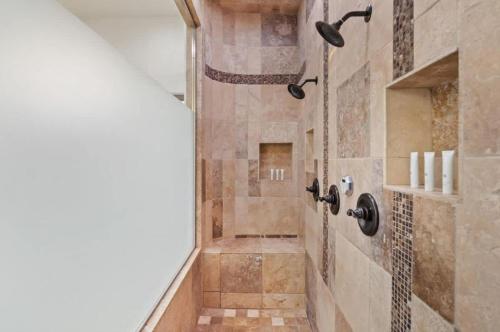 a bathroom with a walk in shower next to a sink at HoZho Residence on Desert Views in Currys Corner