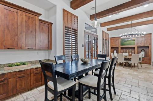 a dining room with a black table and chairs at HoZho Residence on Desert Views in Currys Corner