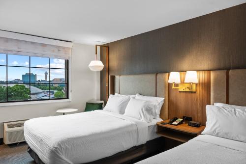 a hotel room with two beds and a window at Holiday Inn Niagara Falls State Park Entry by IHG in Niagara Falls