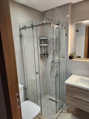 a bathroom with a shower and a toilet and a sink at Rita in Mohammedia