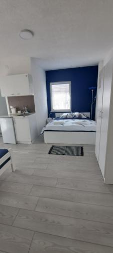 a bedroom with a bed and a blue wall at Villa Sofijana in Ohrid