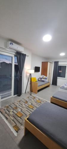 a bedroom with two beds and a couch and a window at Villa Sofijana in Ohrid