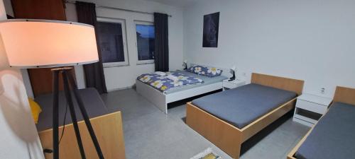 a small room with a bed and a lamp at Villa Sofijana in Ohrid