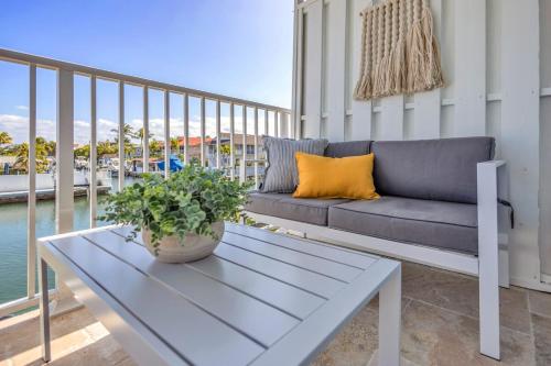 a living room with a couch on a balcony at Ocean Shores Villa 1 in Key Largo with pool & boat slip in Key Largo