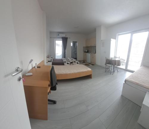 a large bedroom with a bed and a desk and a desk at Villa Sofijana in Ohrid