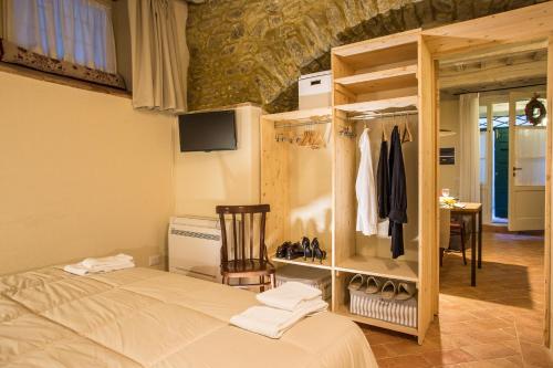 a bedroom with a bed and a chair in a room at Casa Zeni in Cortona