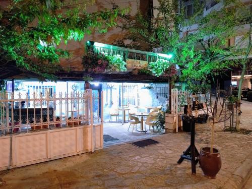 a restaurant with a table and plants on the ceiling at War Bunker Hostel in Sarandë