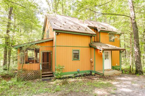 a small yellow house in the woods at Redbird Haven in Berkeley Springs
