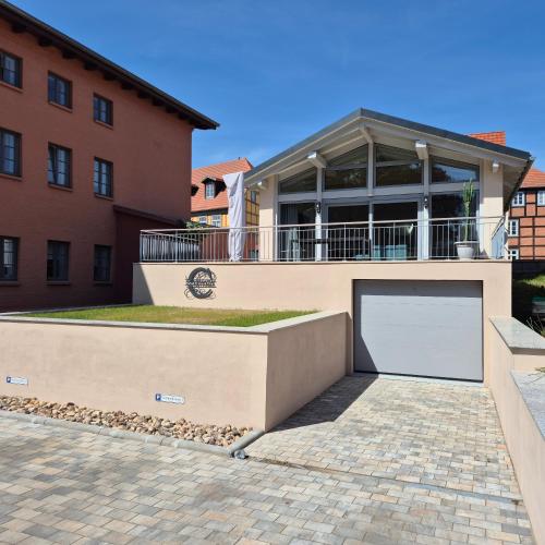 a house with a large garage in front of a building at Constanza in Plau am See