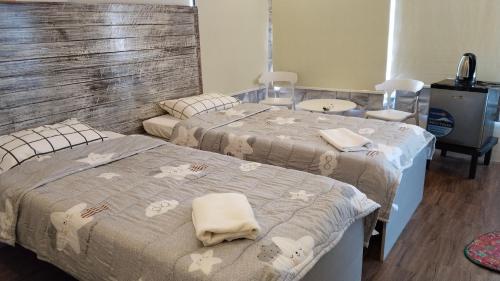 a bedroom with two beds with towels on them at YES Guesthouse in Angeles
