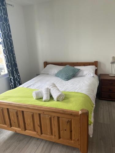 a bedroom with a bed with two towels on it at Graveney House Private Rooms in London