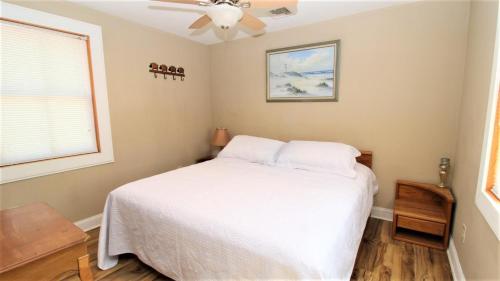 a bedroom with a bed and a ceiling fan at 111 Leaming Ave in West Cape May