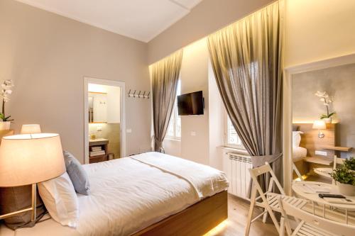 a bedroom with a bed and a desk and a chair at The Spanish Suite Campo de' Fiori in Rome