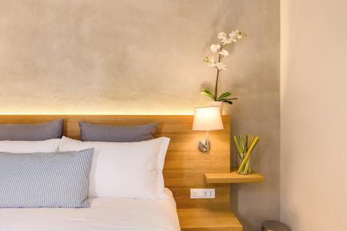 a bedroom with a bed and a vase with flowers at The Spanish Suite Campo de' Fiori in Rome
