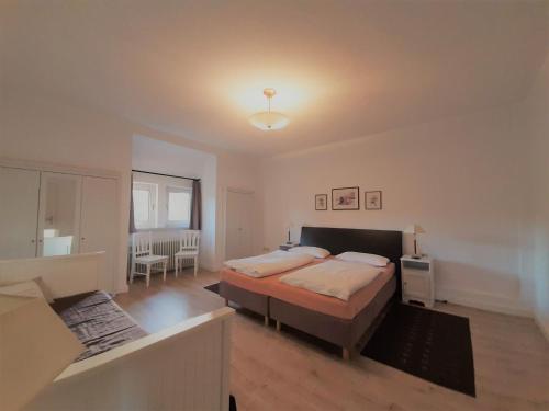 a bedroom with a large bed in a room at City Fewo Stricker in Bad Sachsa
