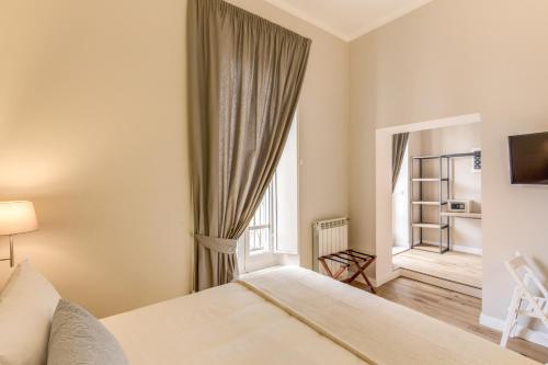 a bedroom with a bed and a large window at The Spanish Suite Campo de' Fiori in Rome