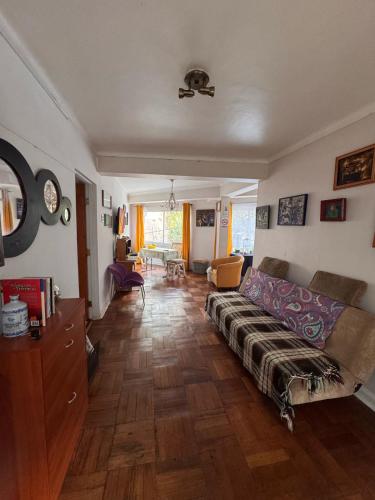 a living room with a couch and a table at Habitación en Valparaíso privada 1 in Valparaíso