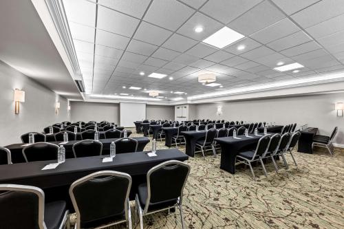 a conference room with black tables and chairs at Best Western Plus Puyallup Hotel in Puyallup