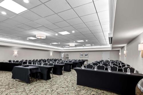 a banquet hall with black tables and chairs at Best Western Plus Puyallup Hotel in Puyallup