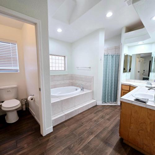 a bathroom with a tub and a toilet and a sink at The Fieldhouse in Blythe