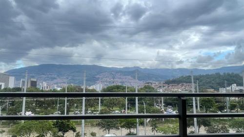 a view of a city with mountains in the background at Aparta estudio muy bien ubicado in Medellín