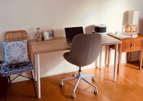 a desk with a chair and a laptop computer on it at Phillip Island Central Cowes Pet Friendly Wifi Linen Towels Included Beach House in Cowes