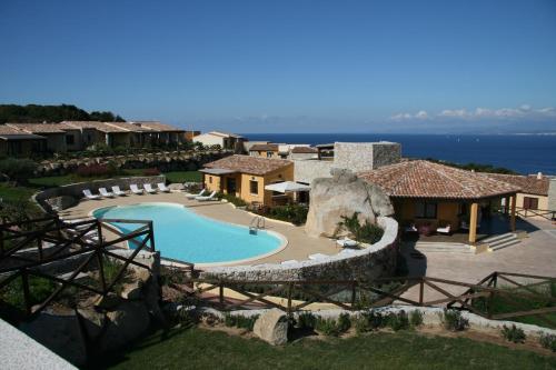 an aerial view of a resort with a swimming pool at Punta Falcone Resort in Santa Teresa Gallura