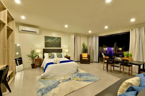 a bedroom with a bed and a desk in a room at Ogma Suites Legazpi in Legazpi