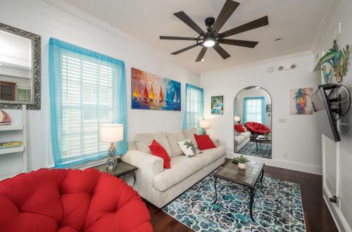 a living room with a couch and a ceiling fan at Heron Hideaway in Key West