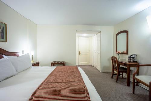 Cama o camas de una habitación en MR Hotel Providencia (ex Hotel Neruda)