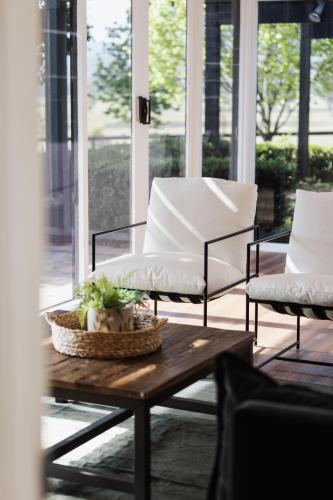 a living room with two chairs and a coffee table at The Wellness Farm Broke in Broke