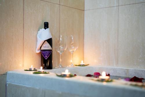 a bottle of wine and two wine glasses on a table at Okay One Hotel in Phumi Ta Phul