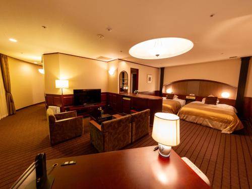 a hotel room with a bed and a television at Shibuya Creston Hotel in Tokyo