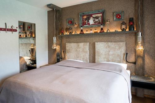 a bedroom with a bed and some shelves on the wall at Boutique Hotel im Auracher Löchl in Kufstein