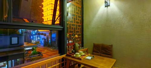 a room with a table and a view of a city at Phoenix Dragon M.I.C.E Hotel in Kunming