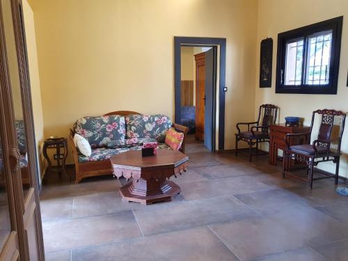 a living room with a couch and a table at Villa Jen'uka with private pool in Callian