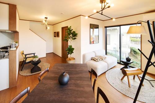 a living room with a couch and a table at Maigre atelier in Ito