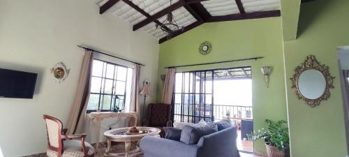 a living room with a couch and a mirror at Colonial Suite Constanza in Arroyo Frío