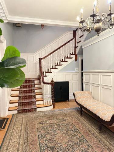 a living room with a staircase and a couch at Authentic Spacious 1BDR In Downtown Montreal in Montréal