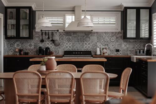 a kitchen with a table and chairs in it at The Wellness Farm Broke in Broke