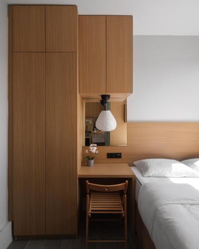 a bedroom with a bed and a desk with a chair at Coca Cabana in Bandung