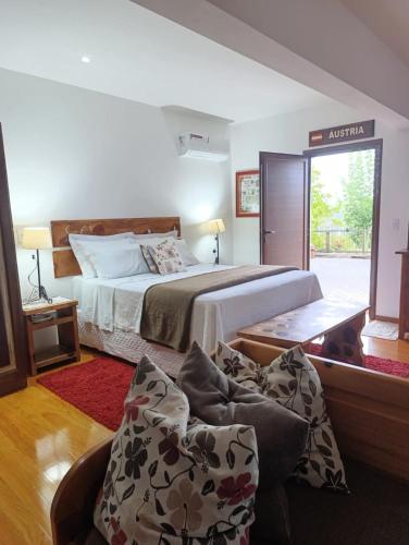 a bedroom with a large bed and a couch at Viena Hospedaria in Treze Tílias