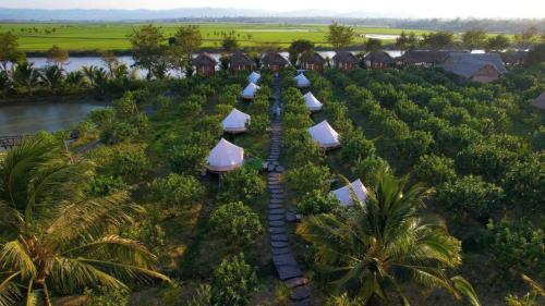 an aerial view of a resort with a river and trees at Đảo Xanh Ecofarm in Buon Ma Thuot
