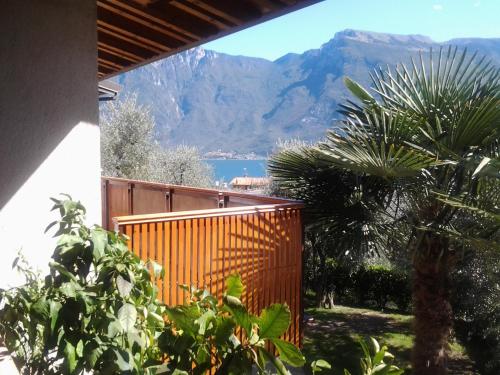 a house with a fence and a view of a mountain at Residence Miravalle in Limone sul Garda