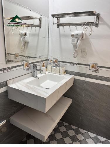 a bathroom with a white sink and a mirror at VuLinh Family -Homestay in Yên Bình